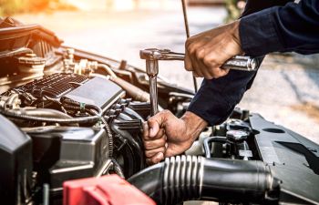 A mechanic repairing a car.