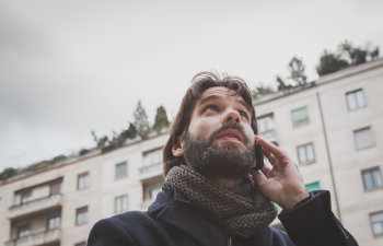 man with beard talks on a mobile